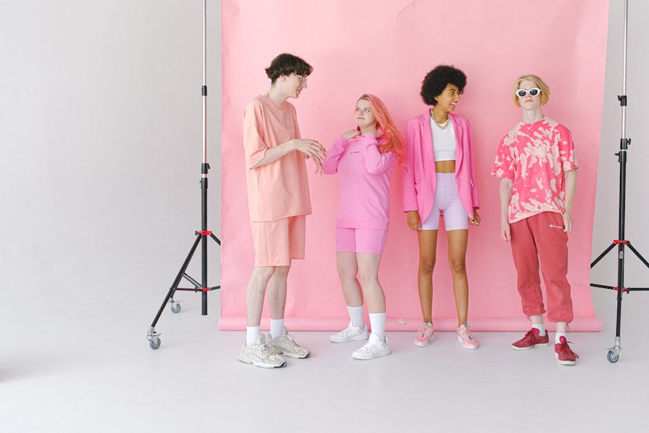 Full body of diverse teenage friends talking and smiling in professional photo studio with special equipment