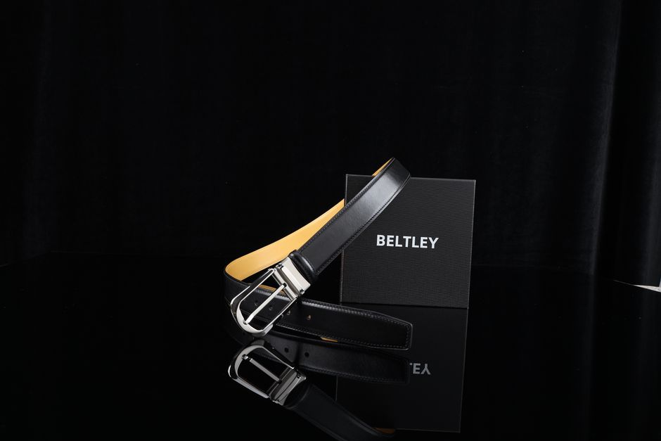 Stylish black leather belt with a sleek metal buckle, perfect for formal wear or gifting.
