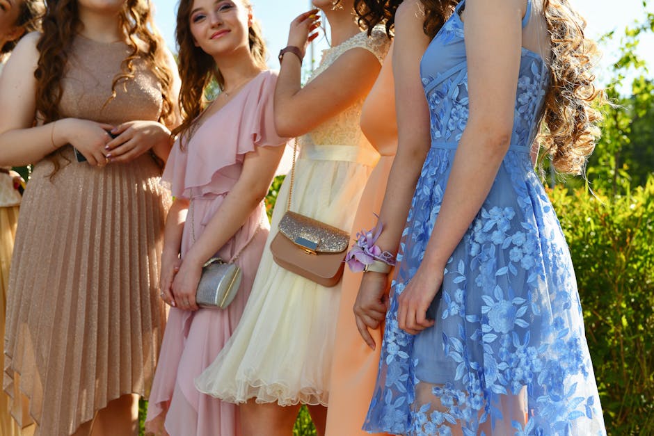 A group of women enjoying a sunny outdoor event dressed in elegant, colorful gowns.